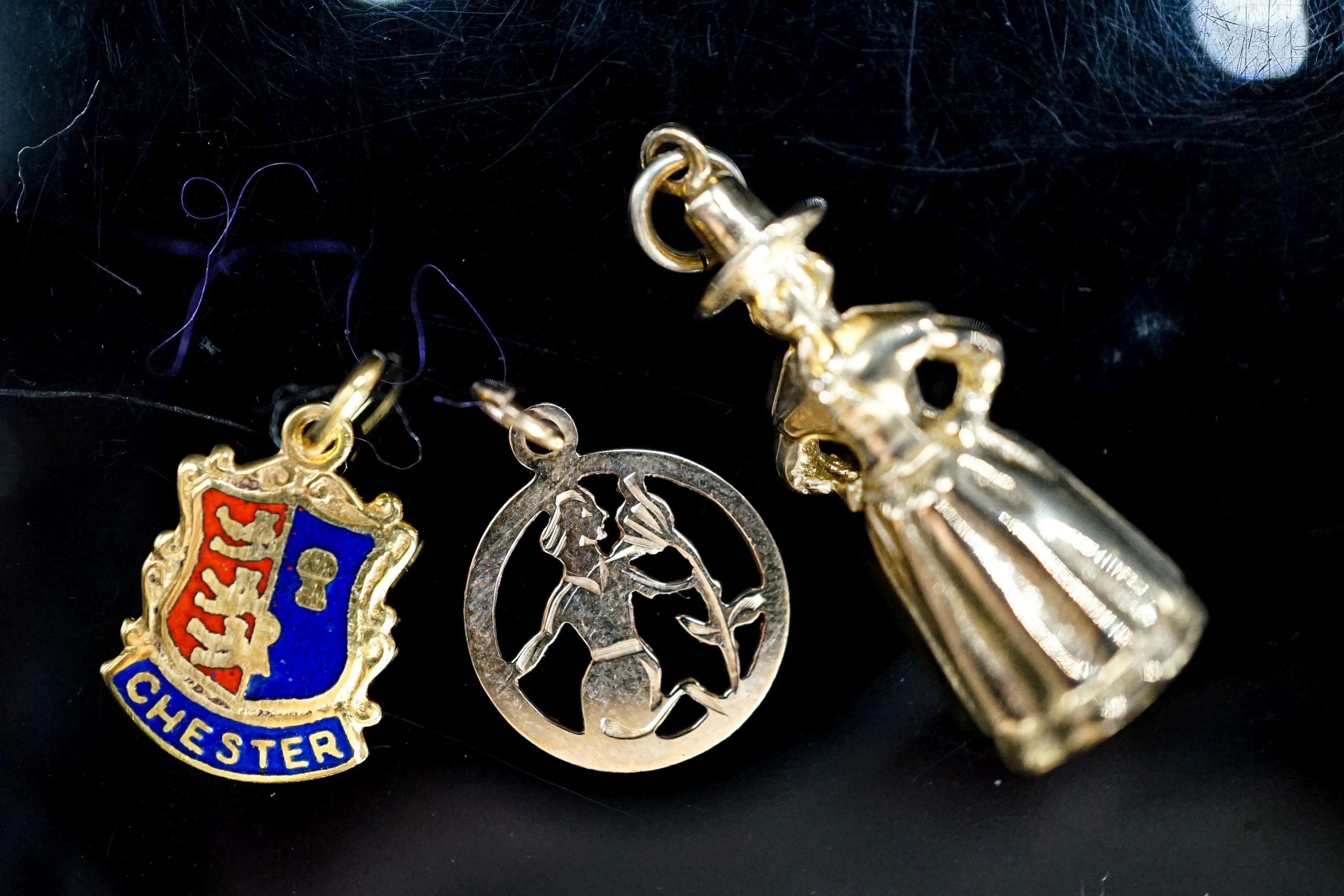 Three assorted 9ct gold charms, including St. Christopher, 6.8 grams.